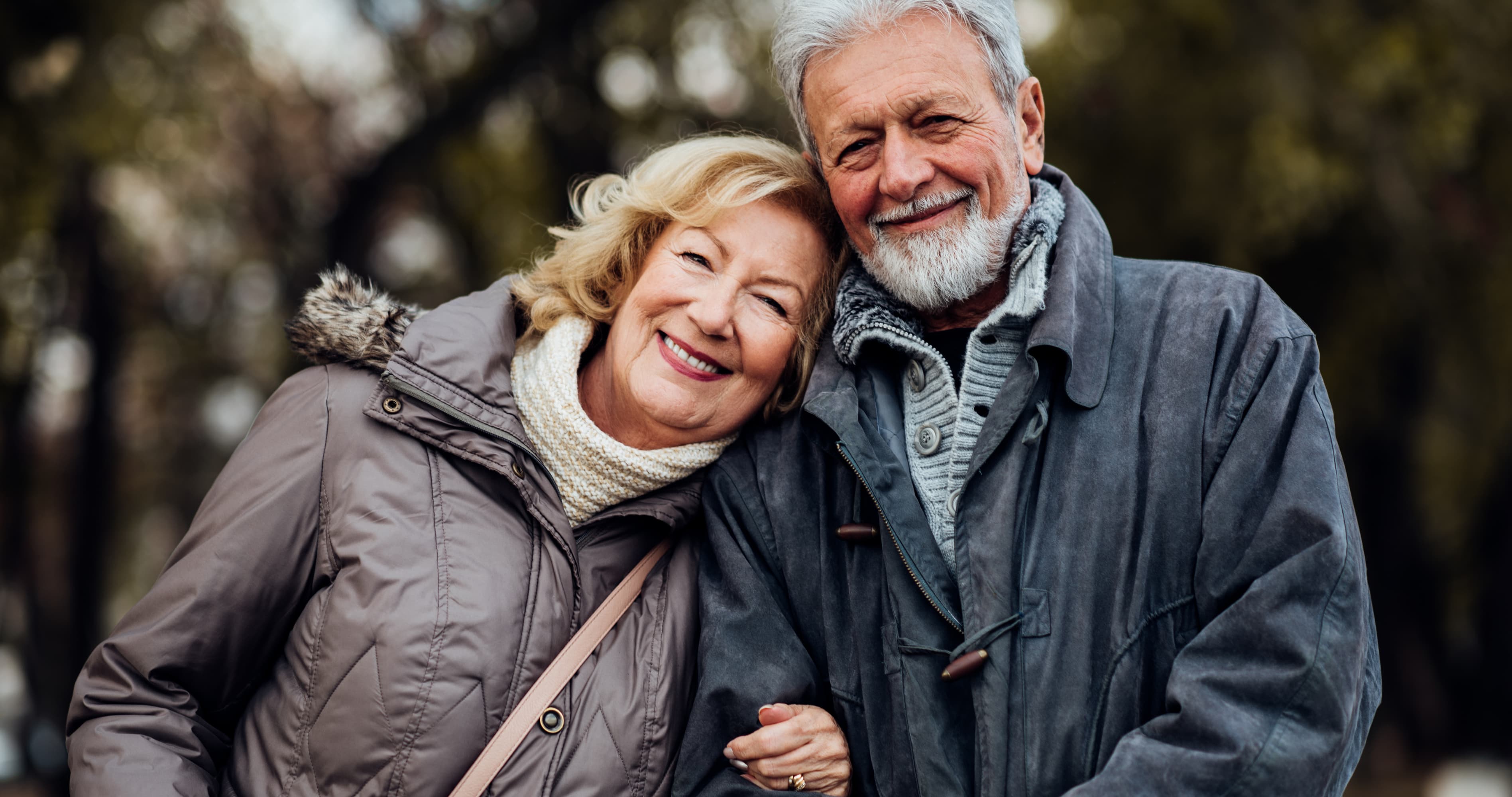 Older married couple smiling together outdoors, showing lasting love and long-term goals for married couples