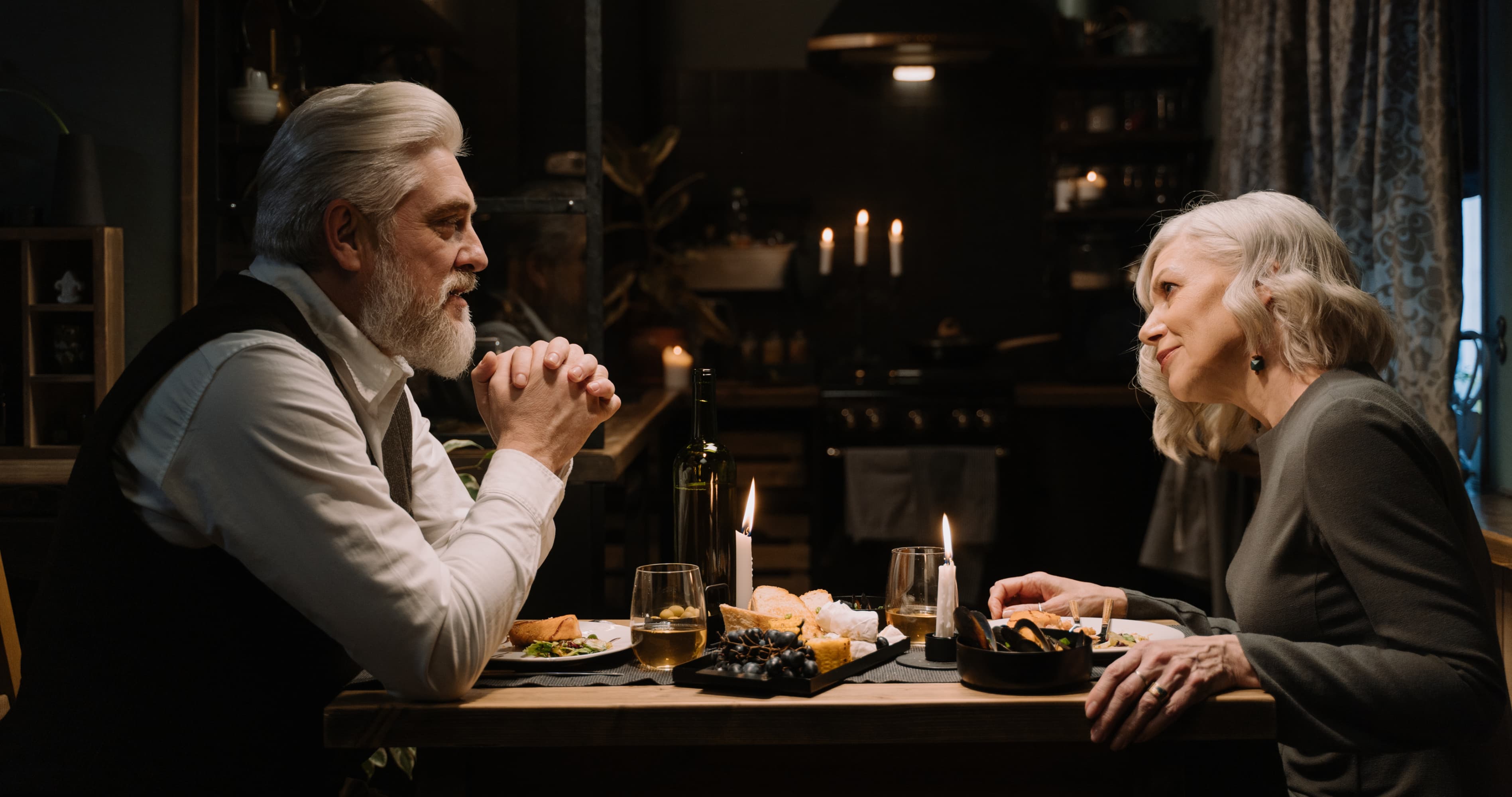 Older couple sharing a calm dinner conversation, showing respect as the foundation of emotional safety in a healthy relationship.
