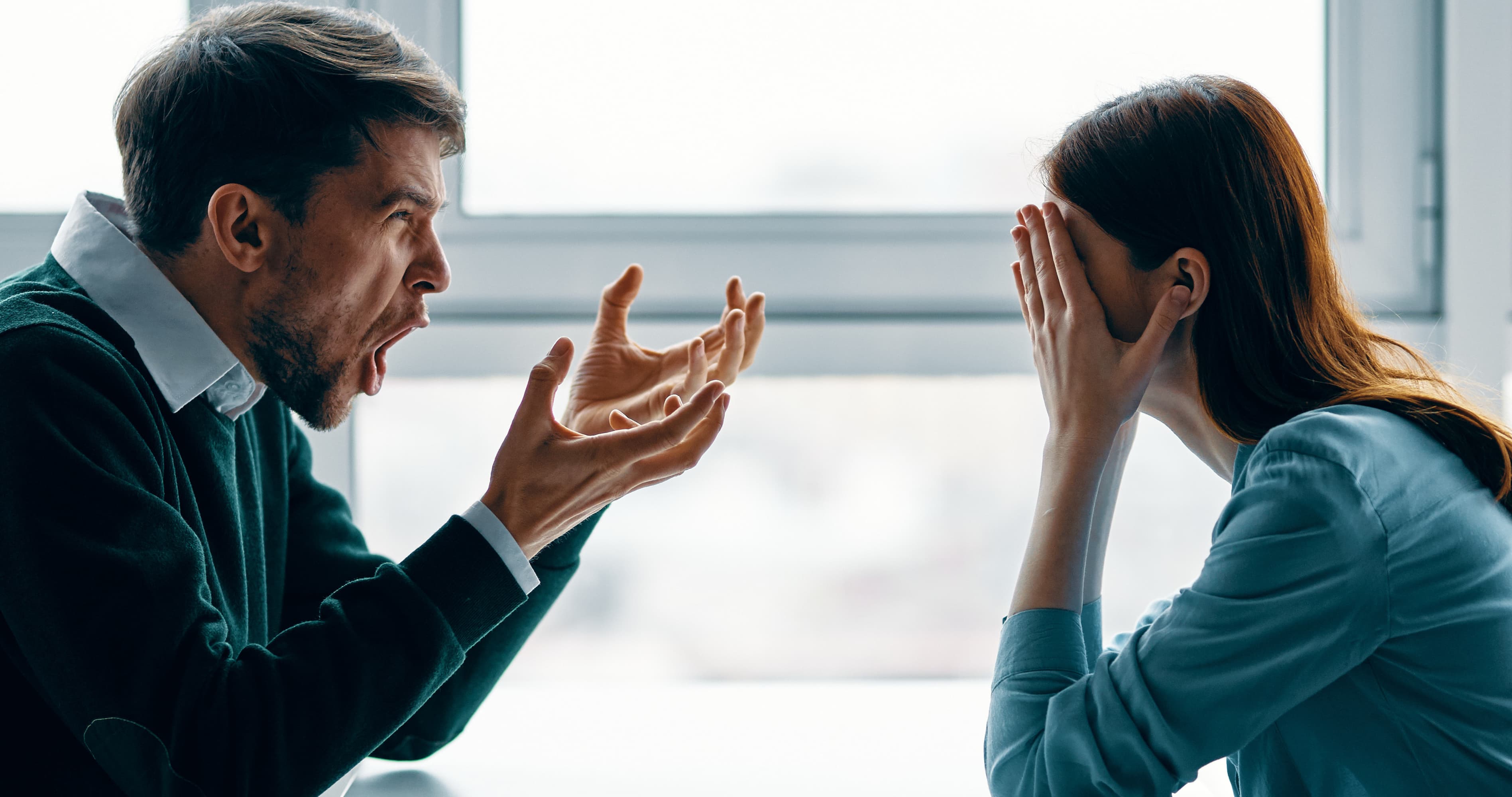 Couple arguing during a stressful conversation, showing marriage burnout, emotional exhaustion, and relationship conflict.