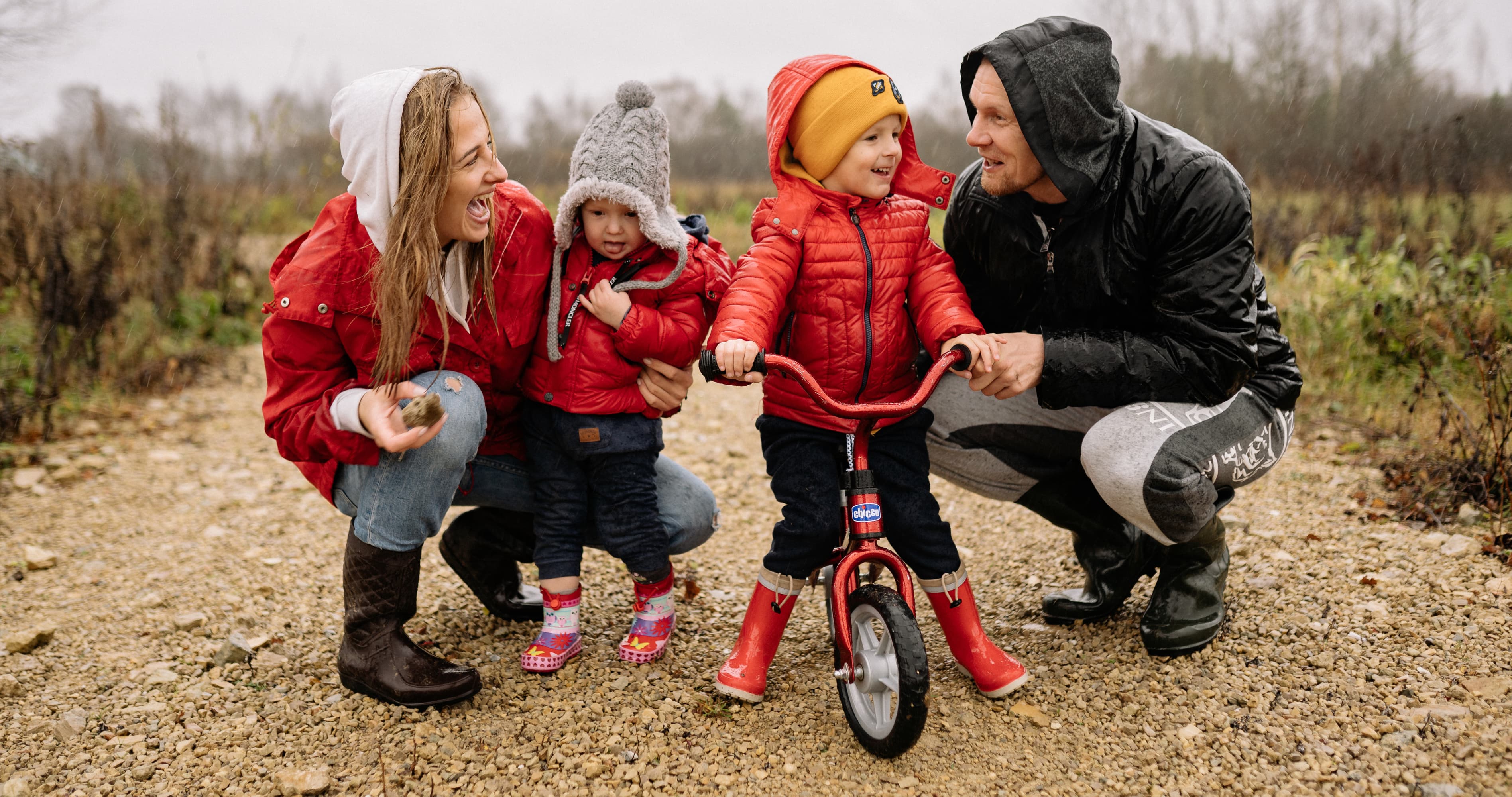 A warm family moment showing parents and young children spending quality time outdoors, representing love, connection, marriage, parenting, and family bonding.
