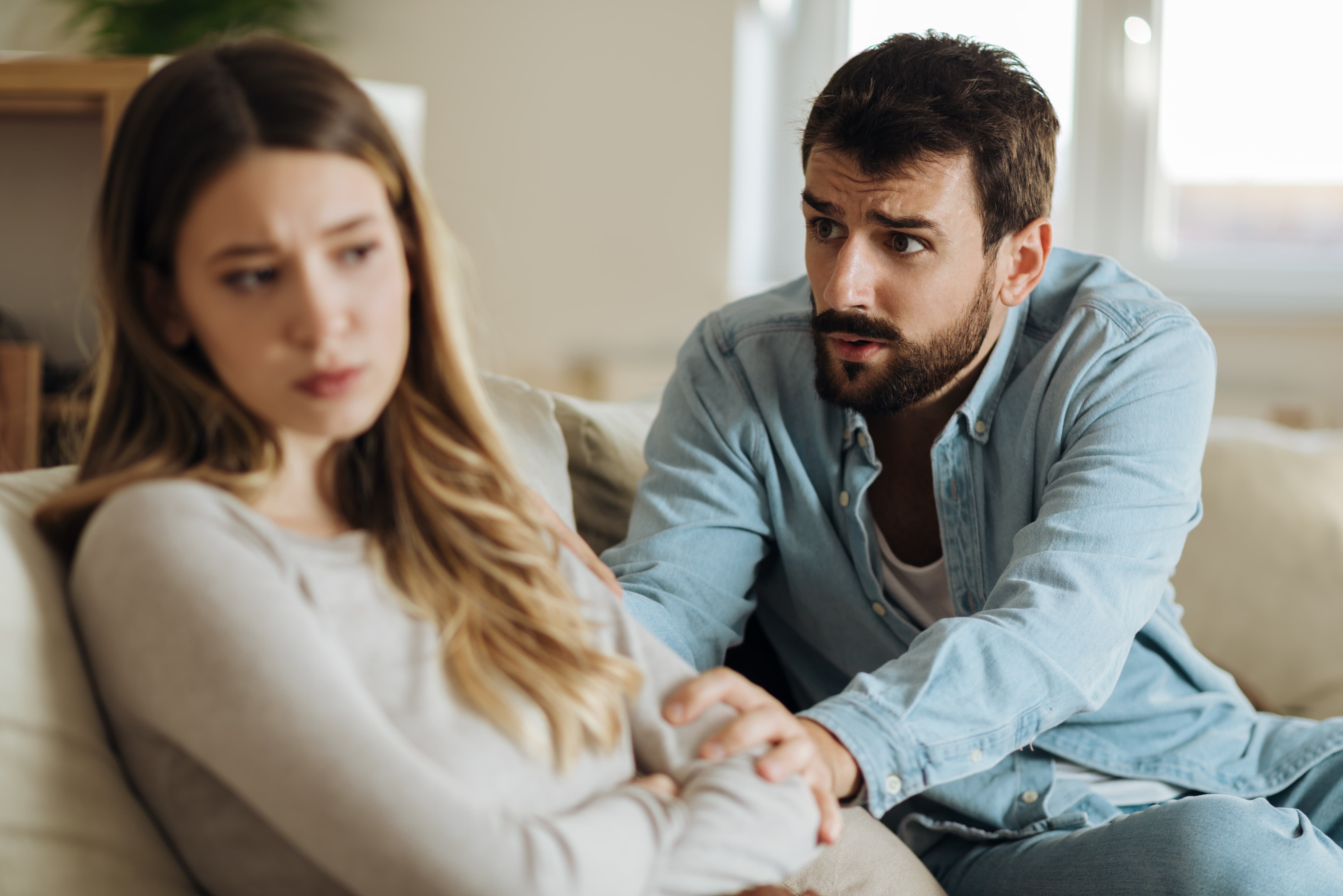 Couple having a serious conversation at home, showing relationship repair skills, emotional support, and conflict healing.