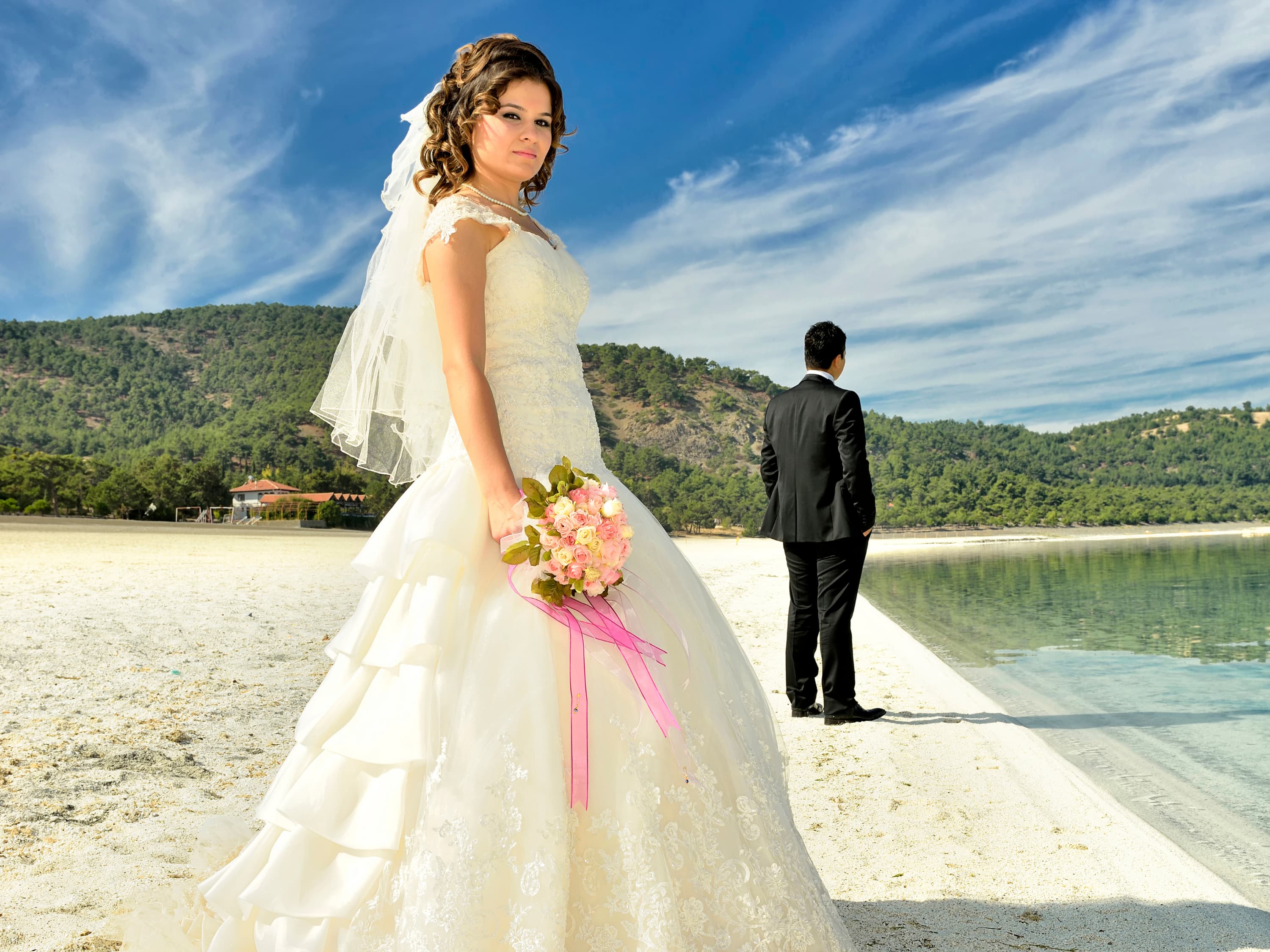 A newly married couple posing closely on the beach, symbolising hope while learning how to rebuild your marriage.
