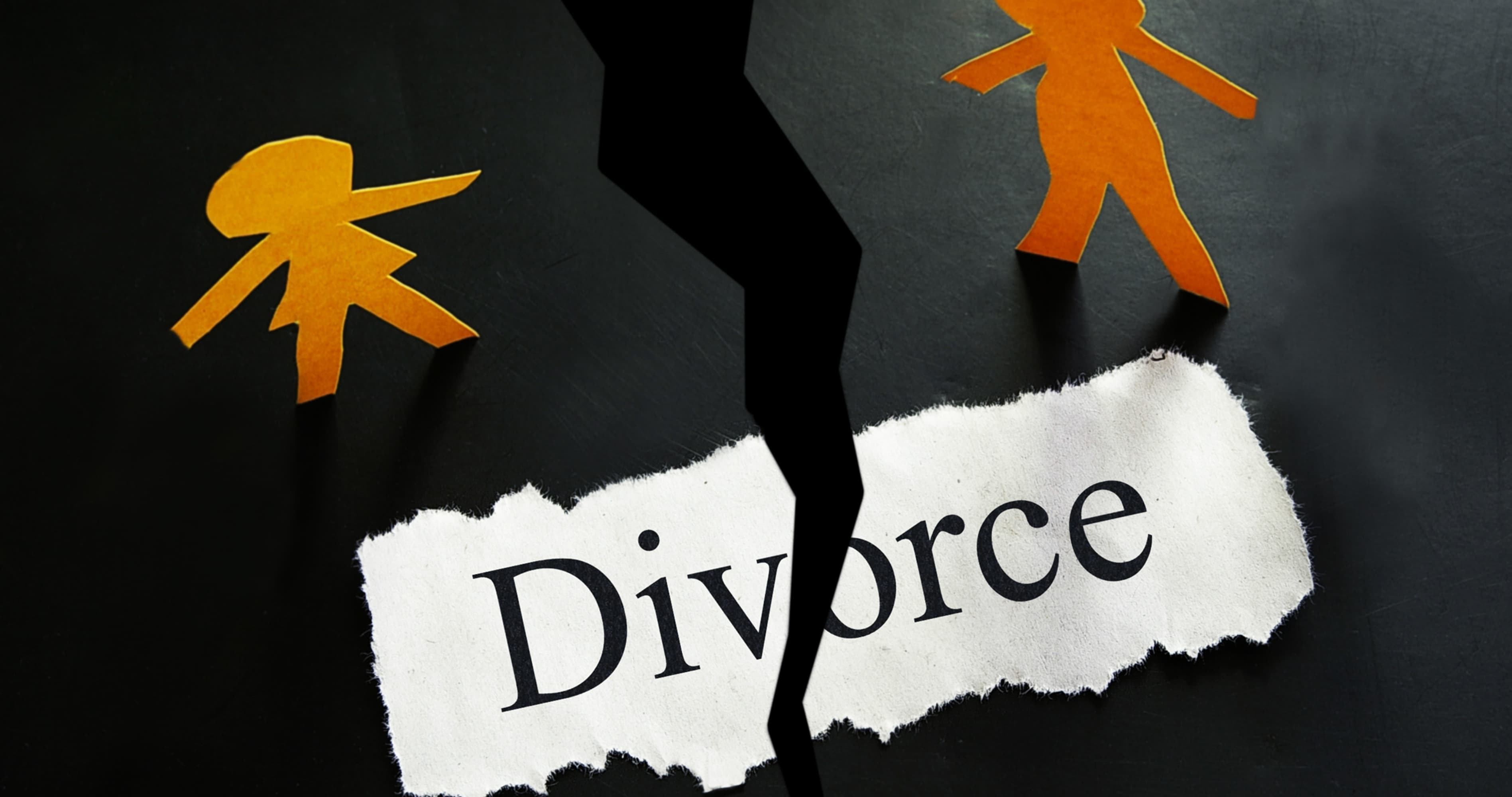 Two orange paper figures separating beside a torn paper that reads "Divorce".